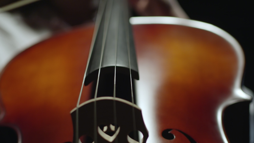 Cello player. Cellist hands playing cello with bow. Violoncello orchestra musical instrument closeup | Shutterstock HD Video #1080228461