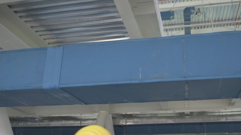 Detail of air conditioner duct in a big industrial building under construction. Camera panning