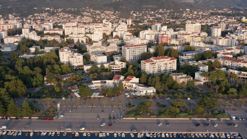 Bar Montenegro - Aerial drone view of white multistory apartment buildings among trees in residential district of city downtown planned with green urbanism in mind, on sunny morning or afternoon.