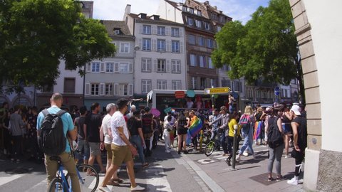 Strasbourg, France - June 2019: Handheld ultra-wide footage of crowd dancing on truck, street at Lesbian Gay Bisexual Transgender LGBT visibility march pride FestiGays