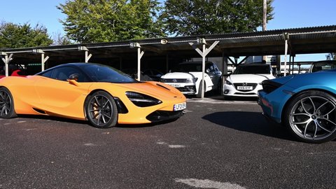 Goodwood, West Sussex, UK, September 30, 2021. Two McLaren 720s 4.0 L M840T twin-turbocharged V8 supercar one in orange and other one in blue.