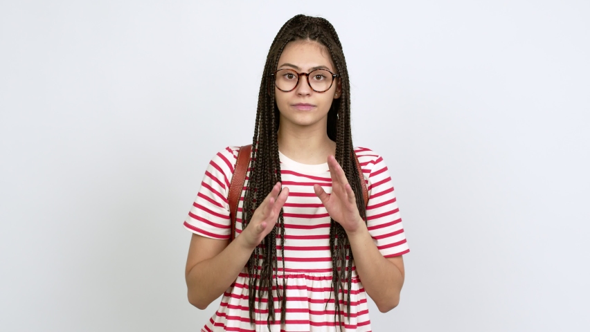 Teenager girl with braids with glasses shouting and announcing something over isolated background