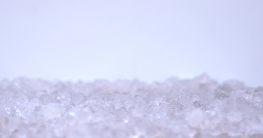 Slices of pear fall from above onto cold ice for fresh or juice on a white background.