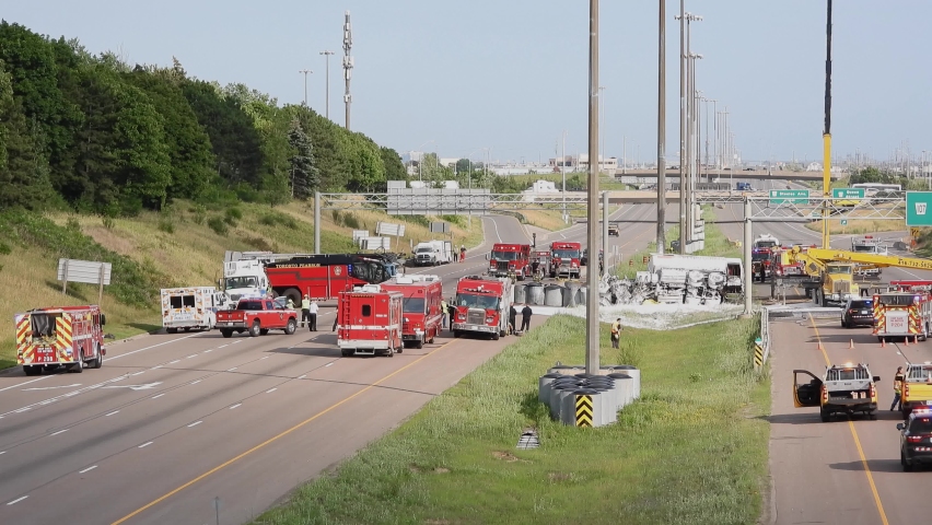 Aftermath of an oil tanker accident in Brampton, Canada. Firetrucks and construction crews arrive to clean up the mess provided assistance.  Royalty-Free Stock Footage #1080248849