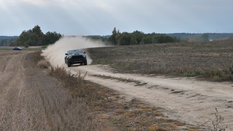 Minsk, Belarus - September 10, 2021: Dodge Ram TRX drives on a gravel road leaving dust behind. Ram TRX is the most powerful series-production pick-up. Its 6,2-liter Supercharged V8 delivers 702 hp.