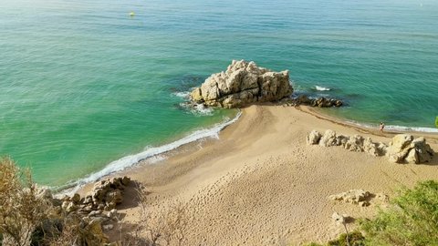 Beautiful paradise beach in the Mediterranean Costa del Maresme Barcelona aerial view turquoise blue water with natural rocks