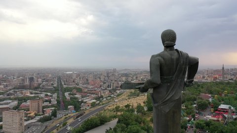 Yerevan, Armenia 06.28.2021  Drone shots of Mother Armenia Statue from back.  In background center of Yerevan. The statue of Mother Armenia. Monument located in Victory Park, Yerevan.