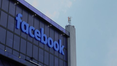 METAVERSE - OCTOBER 4 2021: Facebook outage: Single wrong command took down ‘backbone’ of network, says company. (3D CGI Hyper-lapse Animation of Facebook Logo on Corporate Building.)