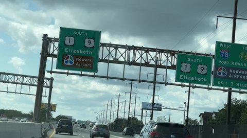 NEW JERSEY, USA - SEPT 18, 2021: sign for Newark Airport and Elizabeth NJ on road from driver pov.