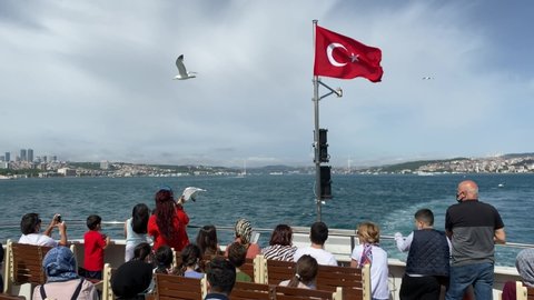 Passengers feed seagulls from a scheduled ferry across the Bosphorus in Istanbul, Turkey. May 26, 2021.