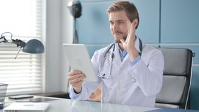 Doctor Talking on Video Call on Tablet in Clinic 