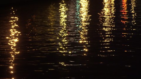 Colored Night City Lights in Water Reflexion