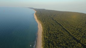 Aerial view of Curonian spit with sandy beach, sea and forest on Baltic sea. top view. 4k drone video