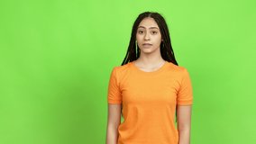 Teenager girl with braids holding something over isolated background. Green screen chroma key