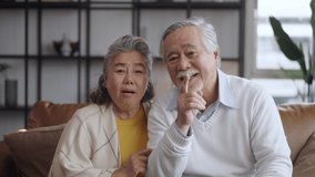 Asian mature senior couple look talk to camera at home. video calling communicate in online chat - Powered by Shutterstock - Get 15% off with code: PIKWIZARD15