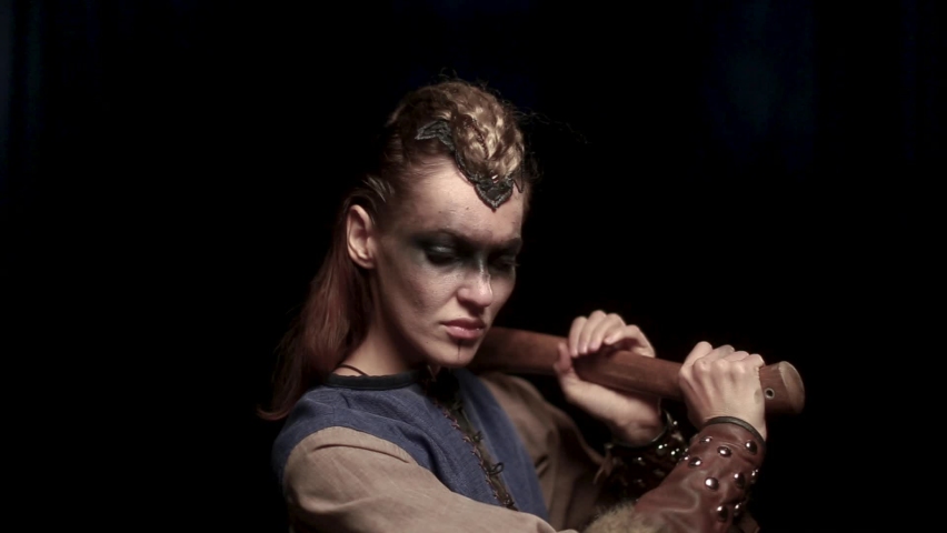 Beautiful female viking woman warrior in battle with bow. Ancient times. Amazon fantasy girl