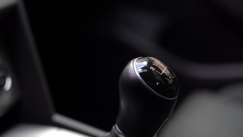 Man driver changing gears with manual transmission gear stick, close up