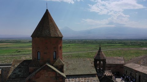 Mount Ararat Aerial view. Khor Virap antique monastery in Armenia. Drone fly over church. Cultivated lands on Ararat plain.