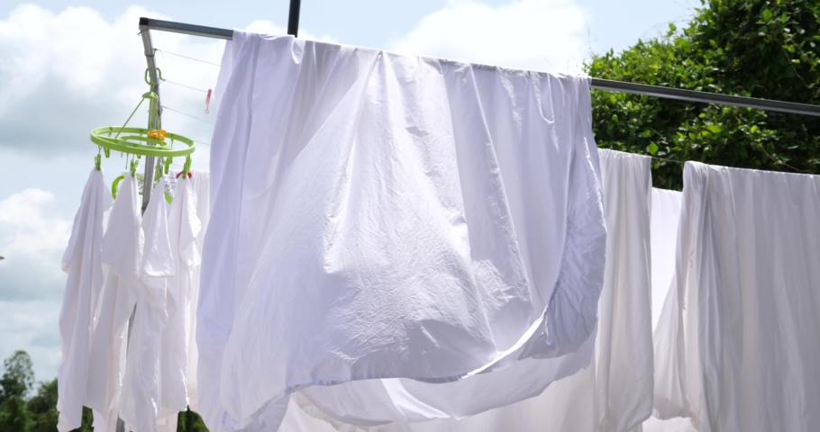 White towels and sheets dry in the sun, Washing laundry ,clothes line,White clothes hung out to dry on a washing line