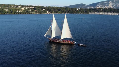 Old large sailing boat on Lake Geneva, Switzerland, Europe - Aerial orbit footage with flag