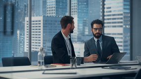 Businesspeople Handshake Greeting in Modern Office: Business Meeting of Two Businessmen Using Laptop and Talking. Top Manager and Partner Investor Brainstorm e-Commerce Software Investment Solution - Powered by Shutterstock - Get 15% off with code: PIKWIZARD15