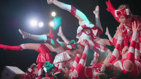 KHERSON, UKRAINE - September 7, 2021 Festival Melpomene of Tavria, show female ballet in cheerleading costumes perform acrobatic stunts during city concert late at night