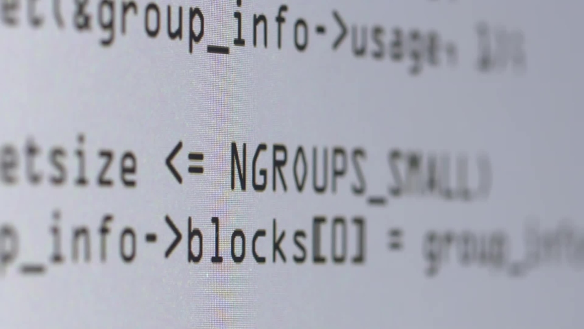 Lines of computer code being generated on a white computer screen. Royalty-Free Stock Footage #1080329777