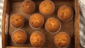 Muffins - delicious pastries. Baked dessert on the tabletop view. Homemade muffin. Portioned cupcakes. Simple food for party. Close-up muffins on a wooden tray