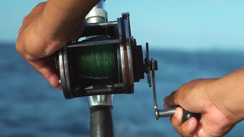 Fishing reels and rods reels for big game fishing trolling tuna Brazil. blue sky and blue water Hawaii islands. Andaman sea  ocean fishing boat Phuket, Thailand. Copy space text Space Indonesia. 2022