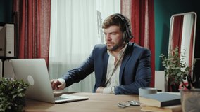 Executive senior CEO businessman in headphones using online meeting virtual conference with laptop computer, remote office, man talking. Financial director leadership leader concept, home office.