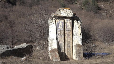 Oldest roadside stella with carving. Such sacred stones (averter) protected traveler, place of rest and prayer on way, as well as avatar (in hinduism), or it's tombstones. Kabardino-Balkaria, Caucasus