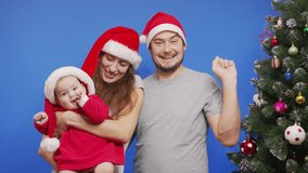 Young Happy Family near Christmas Tree Smiling Waving Hi Making Selfie or Video Message Concept of Family Holidays and New Year.