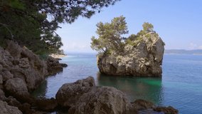 Seascape of the Adriatic Sea, famous stone in Brela resort. Location place Makarska riviera, Croatia, Dalmatia region, Balkans, Europe. Cinematic travel footage. Beauty of earth. Filmed in 4K video.