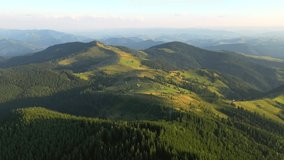 Drone flying over a mountains and green forest. Bird's eye view. Location place Carpathian mountains, Ukraine, Europe. Cinematic aerial shot. Discover the beauty of world. Filmed in 4k, drone video.
