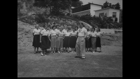 CIRCA 1954 - Women learn to fight off attackers in a self-defense class.