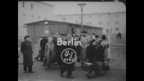 CIRCA 1954 - Refugees from east Germany are processed and fed in west Berlin.
