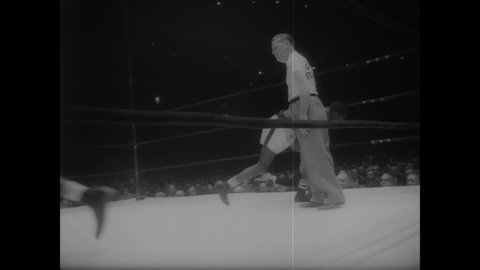 CIRCA 1958 - New York welterweight boxer William Pickett defeats Boston's Willie Moran in the inter-city Golden Gloves championship.