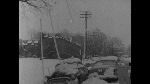 CIRCA 1958 - Power lines are down and whole neighborhoods are blanketed in snow after a blizzard along America's Atlantic coast.