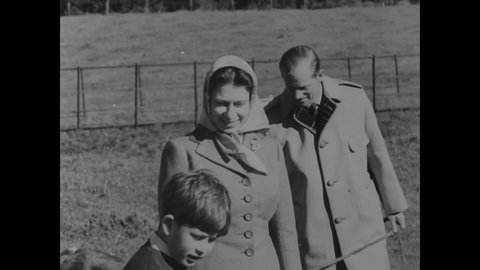 CIRCA 1957 - Queen Elizabeth and Prince Philip take Princess Anne and Prince Charles to the dairy farm on their country estate at Balmoral.