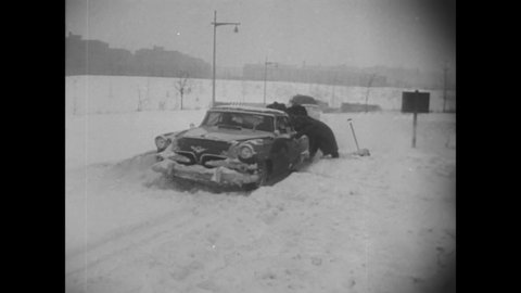 CIRCA 1956 - Cars have to be towed after a snowstorm, while other drivers try simply to dig them out of the snow.