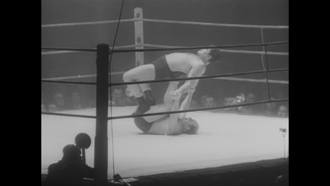 CIRCA 1950 - A wrestling match begins between Frank Sexton and Yvar Martinson.
