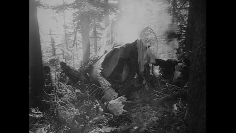 CIRCA 1953 - Rescue workers find the wreckage of a chartered army transport plane in the Cascade mountain range, and there are no survivors.