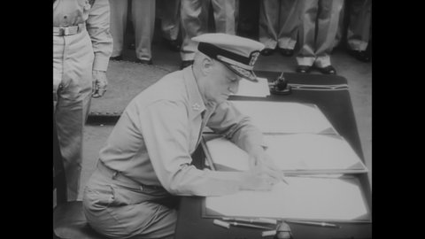 CIRCA 1945 - Japanese and allied representatives sign Japan's formal surrender papers aboard the USS Missouri.
