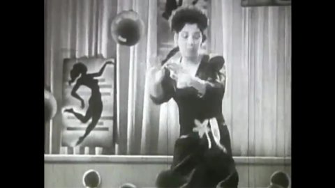 CIRCA 1946 - In this race musical, a woman concludes a dance on stage accompanied by xylophone-led swing music.