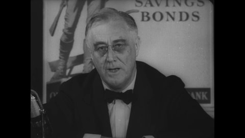 CIRCA 1941 - FDR buys defense bonds from Secretary of the Treasury Henry Morgenthau, and urges all Americans to likewise invest to help win the war.