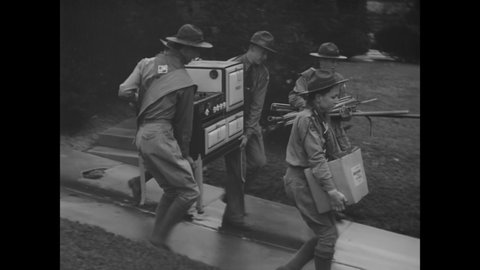 CIRCA 1942 - Boy Scouts run a scrap drive to defeat the Japanese in Dayton, Ohio.