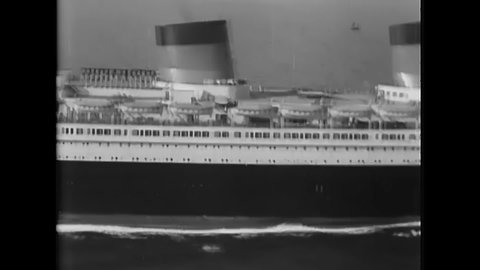 CIRCA 1930s - A French luxury liner pulls up to New York Harbor.