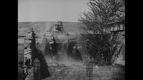 CIRCA 1939 - Army tanks drive through old buildings and barriers in Verdun, France.