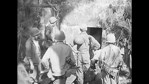 CIRCA 1945 - American soldiers find Japanese children and their civilian parents hiding in tombs in the Philippines.