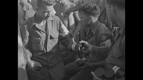 CIRCA 1944 - Ammunition is passed out to American soldiers on the even of their invasion of occupied France.